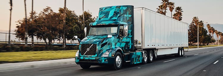 Volvo VNR Electric driving down an open stretch of road.